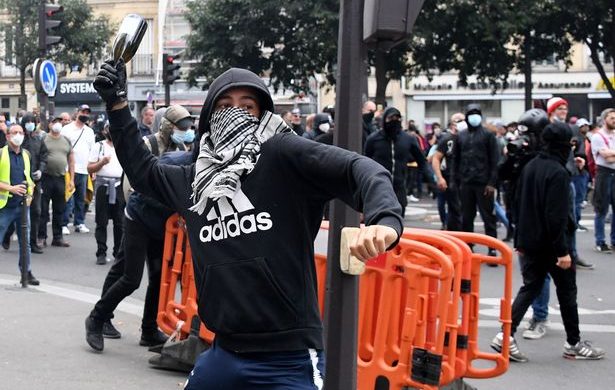 Paris riot police use tear gas on anti-vaxxers as huge crowds clash over Covid passports